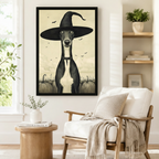 Gothic-style framed wall art featuring a greyhound dog in a tall witch hat with flying bats, styled beside a linen armchair in a Scandinavian reading nook